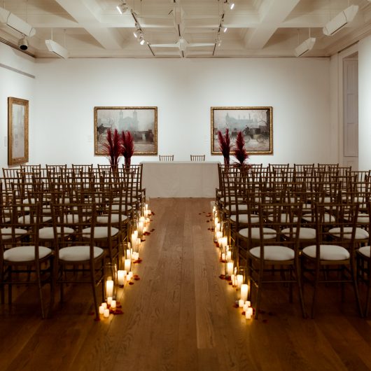 Wedding set up in gallery 16 detailing chairs and lights in the aisle