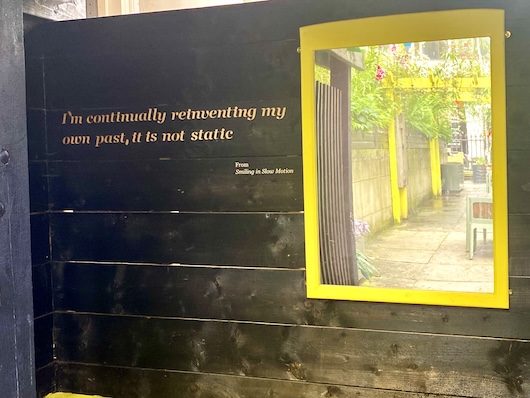 This image shows a quote displayed on a wall, which reads
