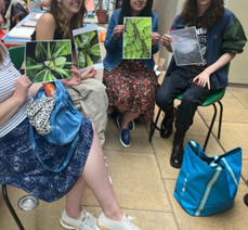a group with their printed outcomes from the photography workshop